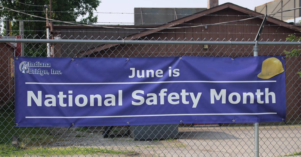 a sign in front of a fence